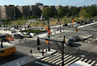 View across intersection of 161st Street to Joyce Kilmer Park from 888 Grand Concourse, designed by Emry Roth, currently a rental building.